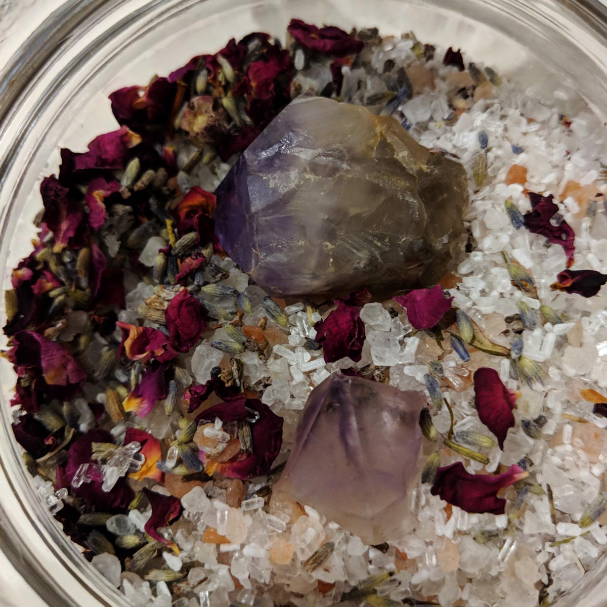 Bath salt blend in a glass jar with two amethyst points